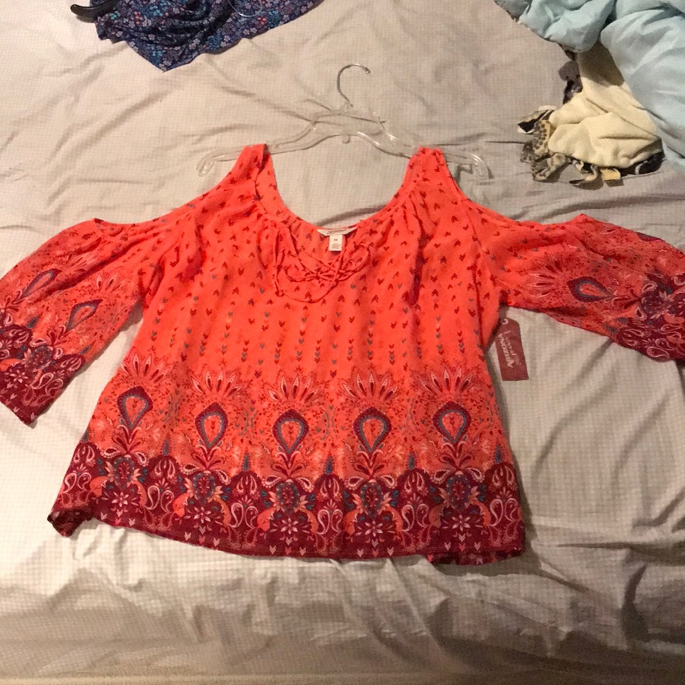 Shirt with shoulder cut outs and laced up top